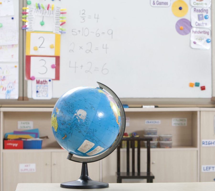 Globe sitting on a desk in a classroom